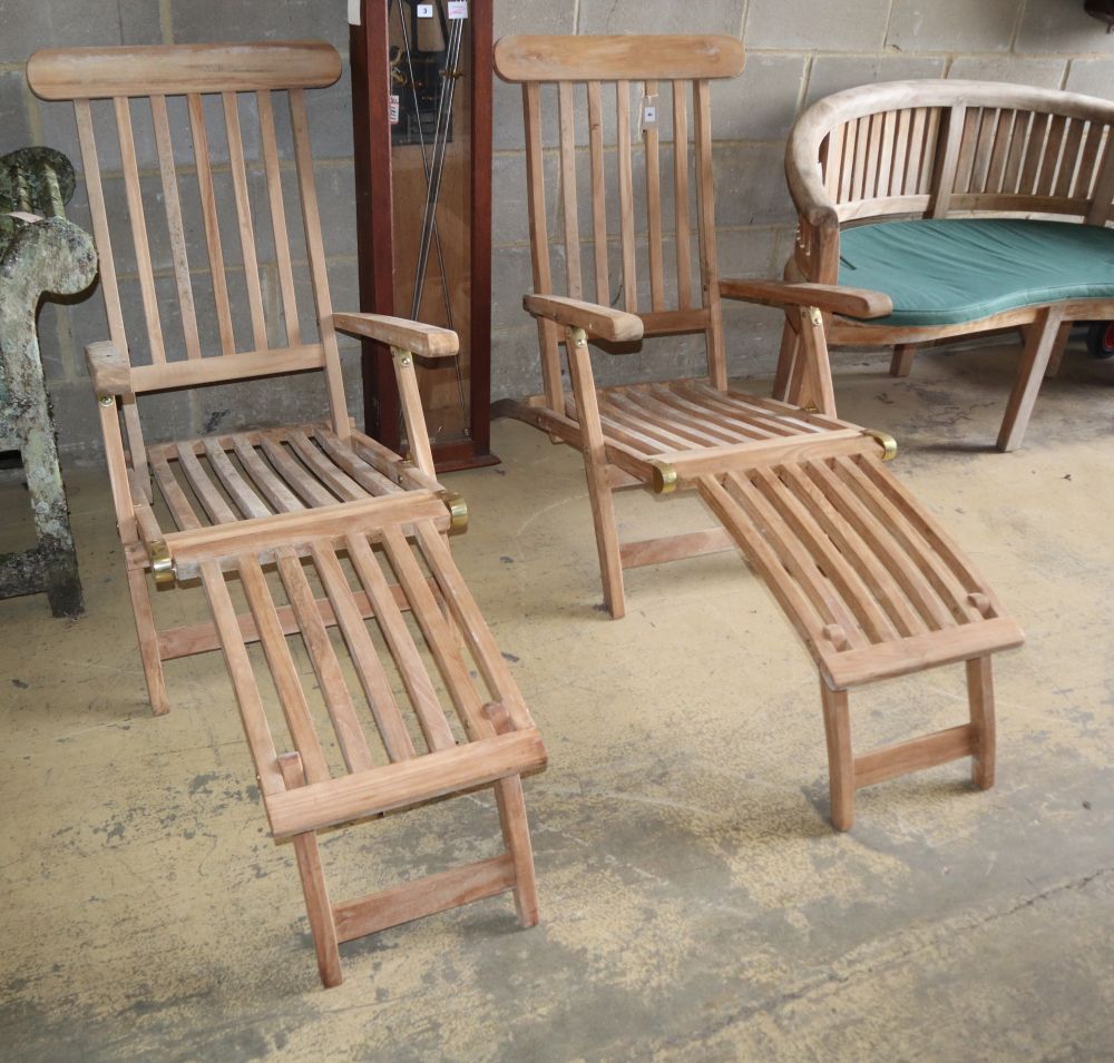 A pair of teak garden steamer chairs